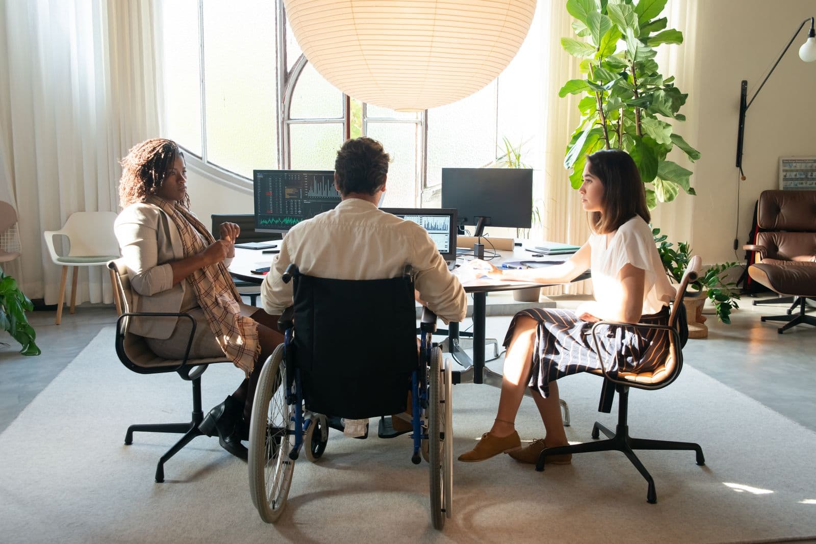 An inclusive, modern office team collaborating in natural light