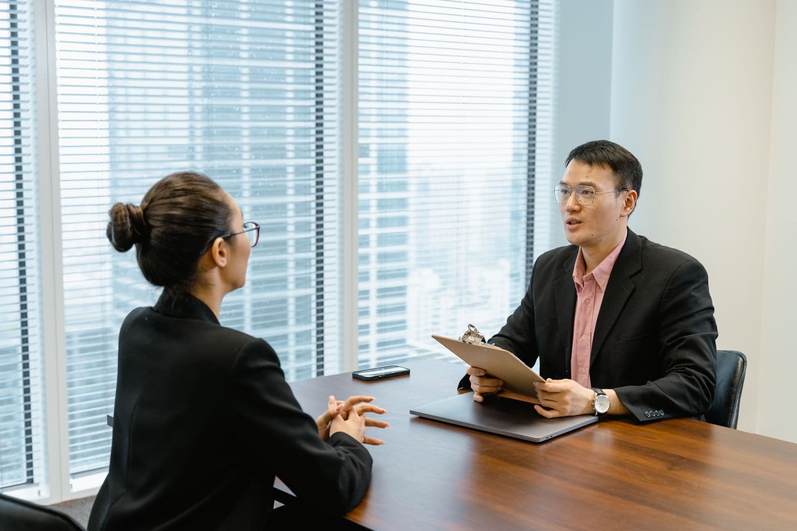 Recruitment consultant walking a client through salary benchmark figures