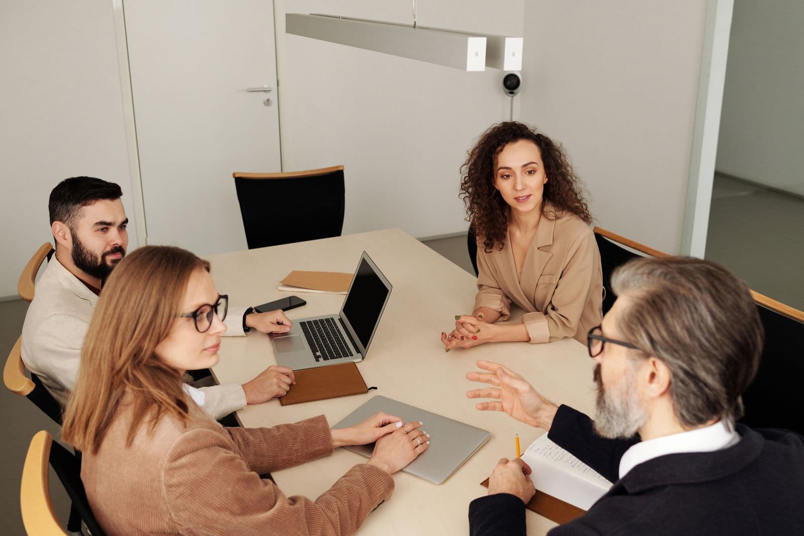 A hiring team reviewing candidates together in a boardroom