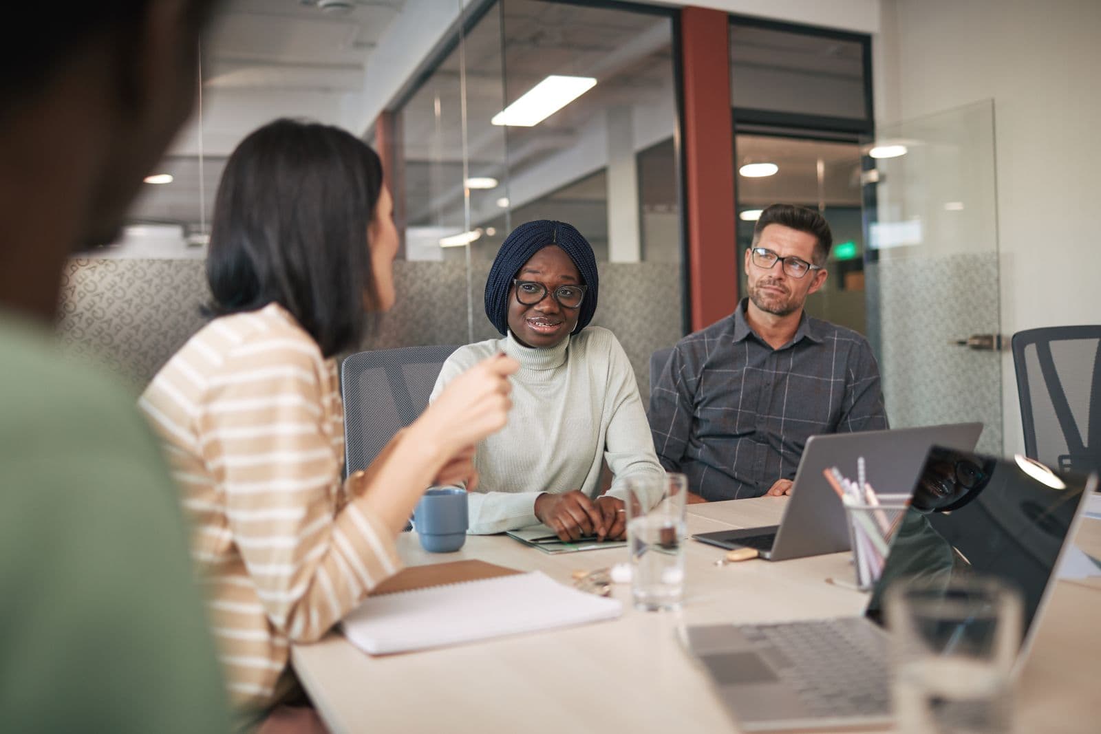 Recruitment consultants discussing a shortlist around a meeting table