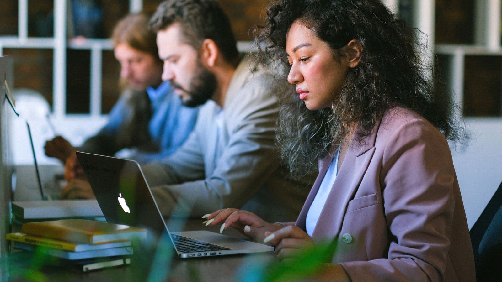 SAP S/4HANA consultants reviewing work together, from the Henley Morgan article SAP S/4HANA Migration 2027: The US Talent Crunch Ahead